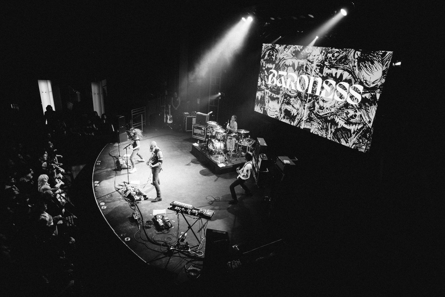 Full Baroness set seen from the balcony of The Palace Theatre, Calgary, the band below a giant logo screen, black and white