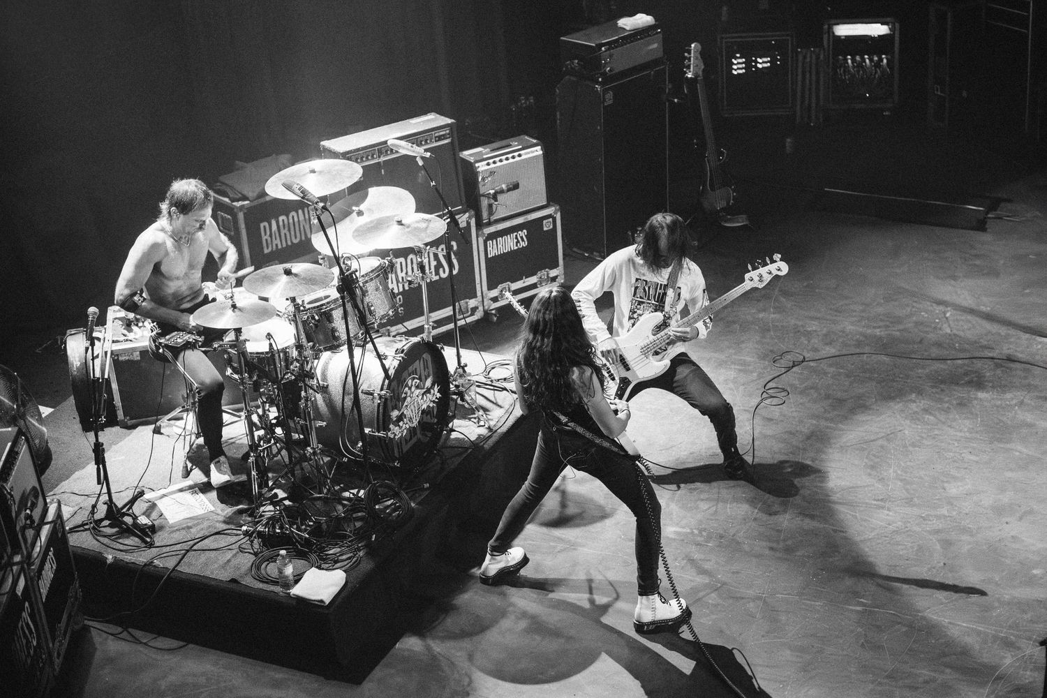 Overhead view of Baroness, drummer and two guitarists before branded amps, The Palace Theatre, Calgary, black and white