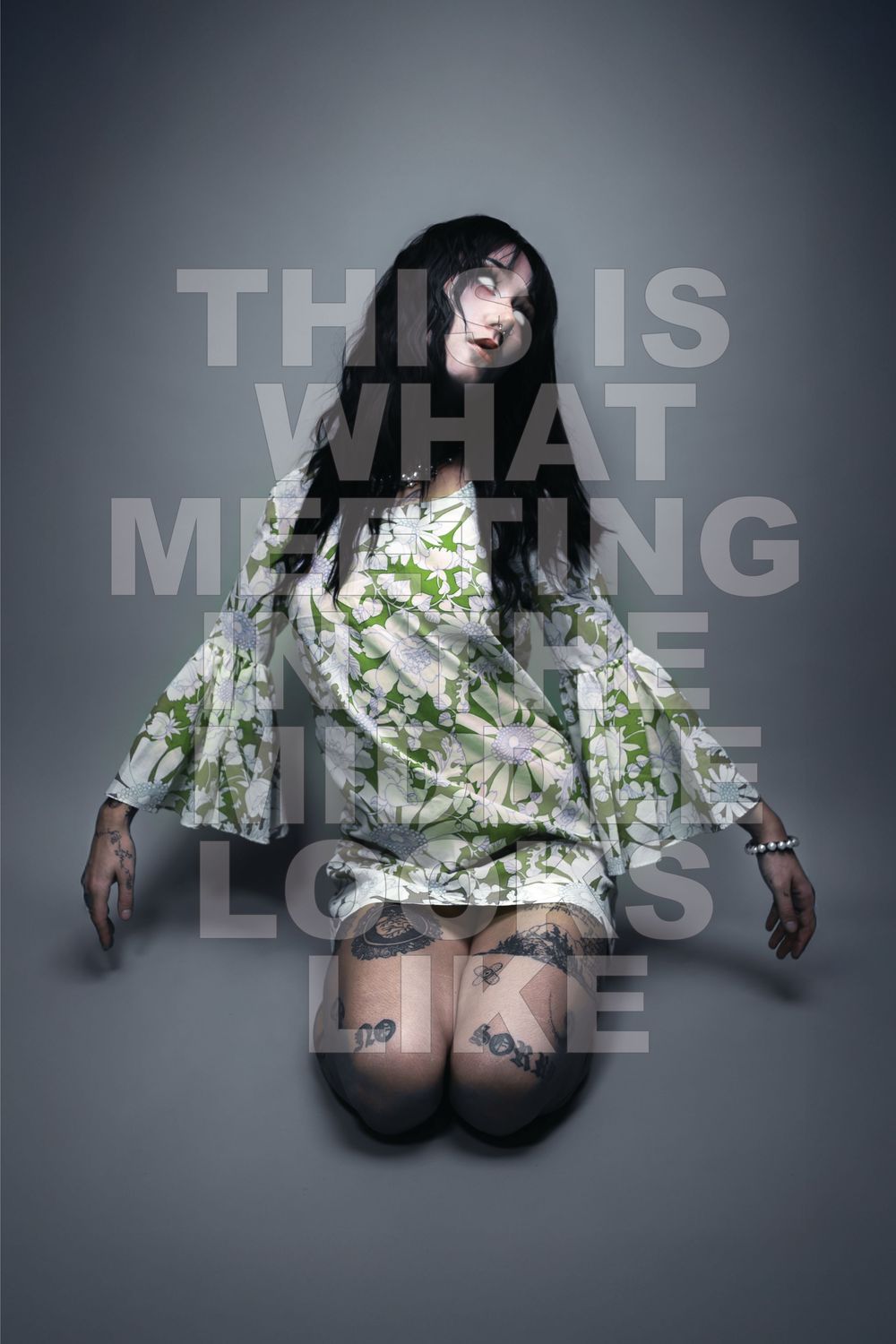 Black-haired model kneels in a green floral bell-sleeve dress on grey under the series title, Pastel Goths, Edmonton