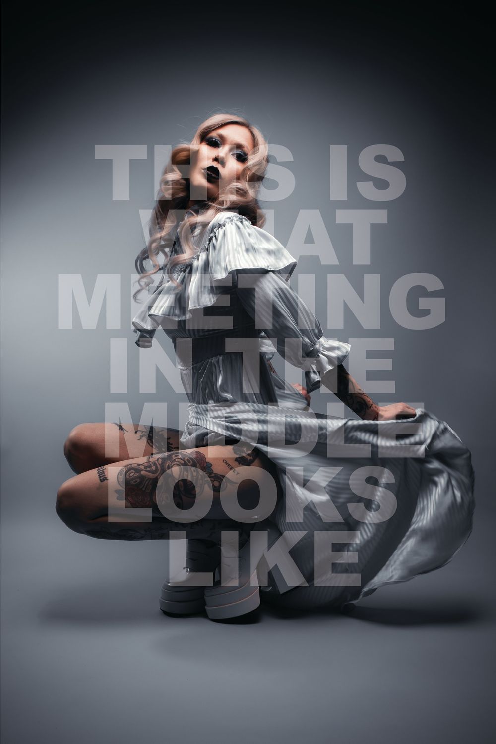 Crouching tattooed model in a ruffled dress on grey, with overlaid words about meeting in the middle, Pastel Goths, Edmonton